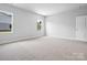 Well-lit bedroom with neutral carpeting and a door at 1062 Bull Dog Ln # 42, Wingate, NC 28174