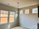 Bright dining area with chandelier and three windows offering natural light at 1066 Bull Dog Ln, Wingate, NC 28174