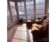 Bright sunroom with wicker furniture and tiled floor, offering ample natural light at 11620 Foggy Bank Ln, Charlotte, NC 28214