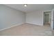 Bedroom with neutral walls, carpet, and access to hallway at 11628 Eastwind Dr, Charlotte, NC 28273