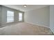 Well-lit bedroom with neutral walls and carpet flooring at 11628 Eastwind Dr, Charlotte, NC 28273