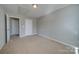 Simple bedroom with carpet flooring and access to other rooms at 11628 Eastwind Dr, Charlotte, NC 28273