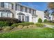 Two story townhouse with landscaping and driveway at 11628 Eastwind Dr, Charlotte, NC 28273