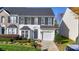 Two-story townhome with a neutral color scheme and landscaping at 11628 Eastwind Dr, Charlotte, NC 28273