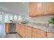 Kitchen with granite countertops, light wood cabinets and stainless steel appliances at 11628 Eastwind Dr, Charlotte, NC 28273