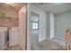 Laundry room with washer, dryer, and access to a bedroom at 11628 Eastwind Dr, Charlotte, NC 28273