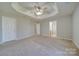 Main bedroom with carpet, ceiling fan and access to bathroom at 11628 Eastwind Dr, Charlotte, NC 28273