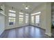 Sunroom with hardwood floors, windows, and French doors at 11628 Eastwind Dr, Charlotte, NC 28273