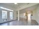 Sunroom with French doors leading to a patio and kitchen views at 11628 Eastwind Dr, Charlotte, NC 28273