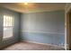 Bedroom with light blue walls, window, and carpet at 707 7Th St, Spencer, NC 28159