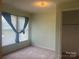 Bedroom with light green walls, window, and carpet at 707 7Th St, Spencer, NC 28159