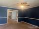 Living room with blue and white walls and carpet at 707 7Th St, Spencer, NC 28159