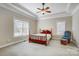 Spacious bedroom with a wooden bed frame, ceiling fan, and window blinds at 9751 Arlington Oaks Dr, Charlotte, NC 28227