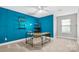 Bright bedroom with teal walls, built-in shelving, and a modern desk at 105 Bess Goforth Dr, Kings Mountain, NC 28086