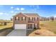 Two-story home with a brick facade, attached garage, and front yard at 109 Vintage Woods Ln, Shelby, NC 28150
