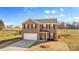 Brick two-story house with a white garage door and landscaping at 109 Vintage Woods Ln, Shelby, NC 28150