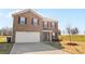 Two-story brick house with a two-car garage and landscaping at 109 Vintage Woods Ln, Shelby, NC 28150