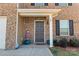 Gray front door with brick facade and seasonal decor at 109 Vintage Woods Ln, Shelby, NC 28150