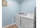 Bright laundry room, washer, dryer, and built-in shelving at 109 Vintage Woods Ln, Shelby, NC 28150