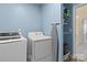 Laundry room with washer, dryer, shelving and access to upper level at 109 Vintage Woods Ln, Shelby, NC 28150