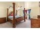 Spacious main bedroom with a large four poster bed and ceiling fan at 109 Vintage Woods Ln, Shelby, NC 28150