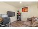 Cozy home office featuring a desk, TV, and comfortable couch at 109 Vintage Woods Ln, Shelby, NC 28150