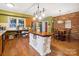 Kitchen features an island, brick accent wall, and hardwood floors at 1202 Brook Dr, Lancaster, SC 29720