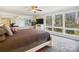 Main bedroom with large windows, mirror wall, and ceiling fan at 1202 Brook Dr, Lancaster, SC 29720