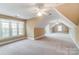 Spacious bedroom with vaulted ceilings, carpeting, and ample natural light at 12539 Overlook Mountain Dr, Charlotte, NC 28216