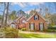 Two-story brick home with landscaped yard and driveway; autumn foliage at 12539 Overlook Mountain Dr, Charlotte, NC 28216