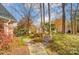 Landscaped walkway with a decorative bench; autumn leaves at 12539 Overlook Mountain Dr, Charlotte, NC 28216