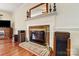 Brick fireplace with a brass screen and hearth at 15001 Chilgrove Ln, Huntersville, NC 28078