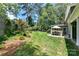 Large backyard with patio, shed and lush greenery at 208 Grey Rd, Davidson, NC 28036