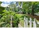 Landscaped backyard with white picket fence and spacious green lawn at 208 Grey Rd, Davidson, NC 28036