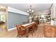 Bright dining room with farmhouse table, wood floors and view into kitchen at 208 Grey Rd, Davidson, NC 28036