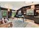 Dark-walled home office with built-in shelving and a cozy sitting area at 208 Grey Rd, Davidson, NC 28036