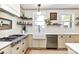 Modern kitchen with white cabinets, farmhouse sink, and ample counter space at 208 Grey Rd, Davidson, NC 28036