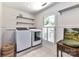 Convenient laundry room with washer, dryer, and extra shelving at 208 Grey Rd, Davidson, NC 28036