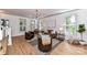 Spacious living room with hardwood floors, comfortable seating, and a modern chandelier at 208 Grey Rd, Davidson, NC 28036