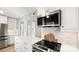 Stainless steel appliances and white shaker cabinets in this updated kitchen at 3631 Maple Glenn Ln, Charlotte, NC 28226