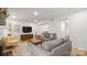 Living room with gray sofas, yellow armchair and fireplace at 3631 Maple Glenn Ln, Charlotte, NC 28226