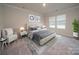 Main bedroom with sitting area and neutral color palette at 4023 Bufflehead Dr, Charlotte, NC 28269