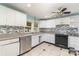 Kitchen with white cabinets, mosaic backsplash and stainless steel appliances at 407 King St, Monroe, NC 28110