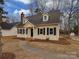 Updated yellow house with black shutters and landscaping at 3062 Beech Ct, Indian Trail, NC 28079