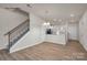 Open concept dining room with hardwood floors, and access to kitchen and stairs at 5156 Tommy Ln # 1301, Stanley, NC 28164
