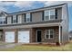 Two-story townhome with brick and siding, two-car garage, and front landscaping at 5156 Tommy Ln # 1301, Stanley, NC 28164