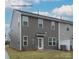 Rear view of townhome showcasing private patio and exterior finishes at 5156 Tommy Ln # 1301, Stanley, NC 28164