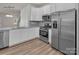Modern kitchen with stainless steel appliances, white cabinets and granite countertops at 5156 Tommy Ln # 1301, Stanley, NC 28164