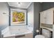 Bathroom with garden tub, toilet and white linen cabinet at 109 Golden Rain Ct, Mount Holly, NC 28120