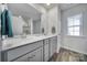 Modern bathroom with double vanity, large mirror, and a shower at 109 Watrous Way, Mooresville, NC 28115